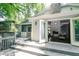Open doors connect the home's interior to a wooden patio, offering scenic outdoor living space at 6409 Lakeland Dr, Raleigh, NC 27612