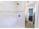 This shower has white subway tile and a gray decorative band, a shower head and controls at 6409 Lakeland Dr, Raleigh, NC 27612