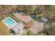 Aerial shot of a home featuring a pool, tennis court, and sports court, offering diverse recreational amenities at 709 Basil Dr, Durham, NC 27713