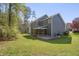 Backyard view of home, showing deck, screened in porch, and yard at 709 Basil Dr, Durham, NC 27713