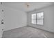 Bright bedroom featuring neutral paint, carpet, natural light from a window and a decorative ceiling light at 709 Basil Dr, Durham, NC 27713