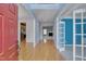 Inviting foyer with hardwood floors, a view of living spaces, and a bright red front door at 709 Basil Dr, Durham, NC 27713