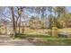 Charming white gazebo overlooking a pond with a fountain, providing a relaxing spot amidst natural beauty at 709 Basil Dr, Durham, NC 27713