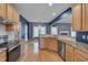 Spacious kitchen with stainless steel appliances, hardwood floors, and granite counters at 709 Basil Dr, Durham, NC 27713