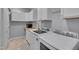 Bright laundry room features white cabinets, modern machines, sink, and ample counter space at 709 Basil Dr, Durham, NC 27713