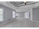 Large main bedroom with tray ceiling, fan, large windows, and ensuite bathroom at 709 Basil Dr, Durham, NC 27713