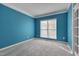 Bright office space with new carpet, blue walls, and ample natural light at 709 Basil Dr, Durham, NC 27713
