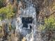 An aerial view of the home highlighting the beautiful roof surrounded by lush trees at 7218 Sunrise Rd, Chapel Hill, NC 27514