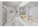 Bright bathroom featuring dual sinks, a large mirror, and a glass-enclosed shower at 7218 Sunrise Rd, Chapel Hill, NC 27514