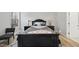 Comfortable bedroom with nice lamps, side tables, black wooden bed frame, and gray area rug at 7218 Sunrise Rd, Chapel Hill, NC 27514