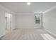 Bright bedroom featuring neutral carpet, crown molding, and a single large window at 7218 Sunrise Rd, Chapel Hill, NC 27514