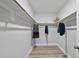 Walk-in closet with wooden floor and rod hanging system provides efficient storage at 7218 Sunrise Rd, Chapel Hill, NC 27514