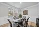 Dining room with an oval table, six chairs, and wainscotting at 7218 Sunrise Rd, Chapel Hill, NC 27514