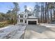 Charming two-story home with a black garage door, white siding, and a welcoming front porch and driveway at 7218 Sunrise Rd, Chapel Hill, NC 27514