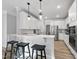 Stylish kitchen with white cabinetry, breakfast bar, and stainless steel appliances at 7218 Sunrise Rd, Chapel Hill, NC 27514