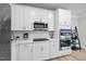 Modern kitchen featuring white cabinets, stainless steel appliances and stone countertops at 7218 Sunrise Rd, Chapel Hill, NC 27514