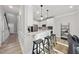 Eat-in kitchen featuring white cabinets, stainless appliances, and barstool seating at 7218 Sunrise Rd, Chapel Hill, NC 27514