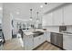 Modern kitchen with white cabinets, stainless steel appliances, and a view to the living area at 7218 Sunrise Rd, Chapel Hill, NC 27514