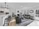 Bright living room with fireplace, modern furniture, and seamless flow to the kitchen at 7218 Sunrise Rd, Chapel Hill, NC 27514