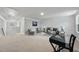 Spacious living room with neutral carpet, custom paneling, and stylish decor at 7218 Sunrise Rd, Chapel Hill, NC 27514