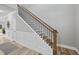 Wooden staircase with black metal railings and white paneled walls at 7218 Sunrise Rd, Chapel Hill, NC 27514