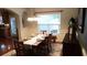 Inviting dining room featuring a wooden table, chandelier, and a large window for natural light at 742 Keystone Park Dr, Morrisville, NC 27560