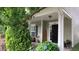 Charming front porch with a welcome sign, seating, and beautiful landscaping at 742 Keystone Park Dr, Morrisville, NC 27560