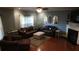Cozy living room featuring plush seating, a fireplace, ceiling fan, and bright natural light at 742 Keystone Park Dr, Morrisville, NC 27560