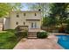 Exterior backyard featuring pool and deck with yellow-sided two story home at 7433 Deer Track Dr, Raleigh, NC 27613