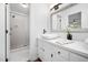 Bright bathroom with a modern vanity, vessel sink, walk-in shower, and neutral finishes at 7433 Deer Track Dr, Raleigh, NC 27613