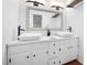 This remodeled bathroom features a double vanity, modern fixtures, and a contemporary design at 7433 Deer Track Dr, Raleigh, NC 27613