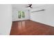 Bedroom with wood-look floors, light walls, and a large window at 7433 Deer Track Dr, Raleigh, NC 27613