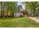 Two-story home with blue shutters, mature trees, and well-kept lawn at 7433 Deer Track Dr, Raleigh, NC 27613