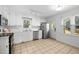 Well-lit kitchen with white cabinets, stainless steel appliances, and a view to the backyard at 7433 Deer Track Dr, Raleigh, NC 27613