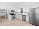 Functional kitchen featuring white cabinets, stainless steel appliances, and ample counter space at 7433 Deer Track Dr, Raleigh, NC 27613