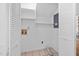 Well-lit laundry room with shelving and hookups at 7433 Deer Track Dr, Raleigh, NC 27613