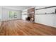 Inviting living room showcasing hardwood floors, a brick fireplace, and built-in shelving for decor and storage at 7433 Deer Track Dr, Raleigh, NC 27613