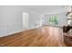 Bright living room boasts hardwood floors, a fireplace, and classic wainscoting for an elegant touch at 7433 Deer Track Dr, Raleigh, NC 27613