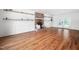 Spacious living room with hardwood floors, a brick fireplace, and open shelving providing ample storage at 7433 Deer Track Dr, Raleigh, NC 27613