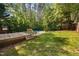 Backyard pool with wooden deck and mature trees offering privacy at 7433 Deer Track Dr, Raleigh, NC 27613