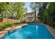Backyard pool featuring a fenced-in yard and yellow siding 2 story home in the background at 7433 Deer Track Dr, Raleigh, NC 27613