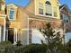 Beautiful townhome with stone accents, a two-car garage, and manicured landscaping at 8002 Upper Lake Dr, Raleigh, NC 27615