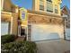 Charming townhome with stone accents, attached two-car garage, and inviting entrance at 8002 Upper Lake Dr, Raleigh, NC 27615