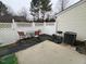 Backyard patio area with a white fence and outdoor seating at 8013 River Water Ct, Raleigh, NC 27616