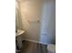 Bright half bathroom with a pedestal sink and neutral walls at 8013 River Water Ct, Raleigh, NC 27616