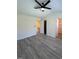 Spacious bedroom featuring gray flooring, a ceiling fan, and closet access at 8013 River Water Ct, Raleigh, NC 27616