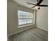 Bedroom features hardwood flooring, fan and window, and neutral paint at 8013 River Water Ct, Raleigh, NC 27616