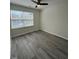Bedroom features hardwood flooring, fan and window, and neutral paint at 8013 River Water Ct, Raleigh, NC 27616