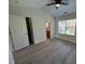 Bedroom with view to en-suite bath, featuring new floors and a ceiling fan at 8013 River Water Ct, Raleigh, NC 27616