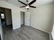 Bedroom featuring ceiling fan, closet, and hardwood flooring at 8013 River Water Ct, Raleigh, NC 27616